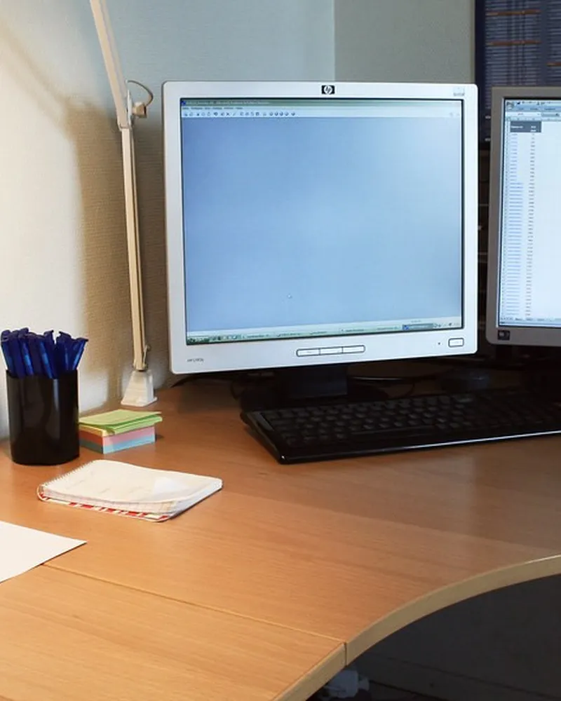 Illustrative photo of monitor arm / setup, not the exact Amazon Basics Monitor Stand Riser