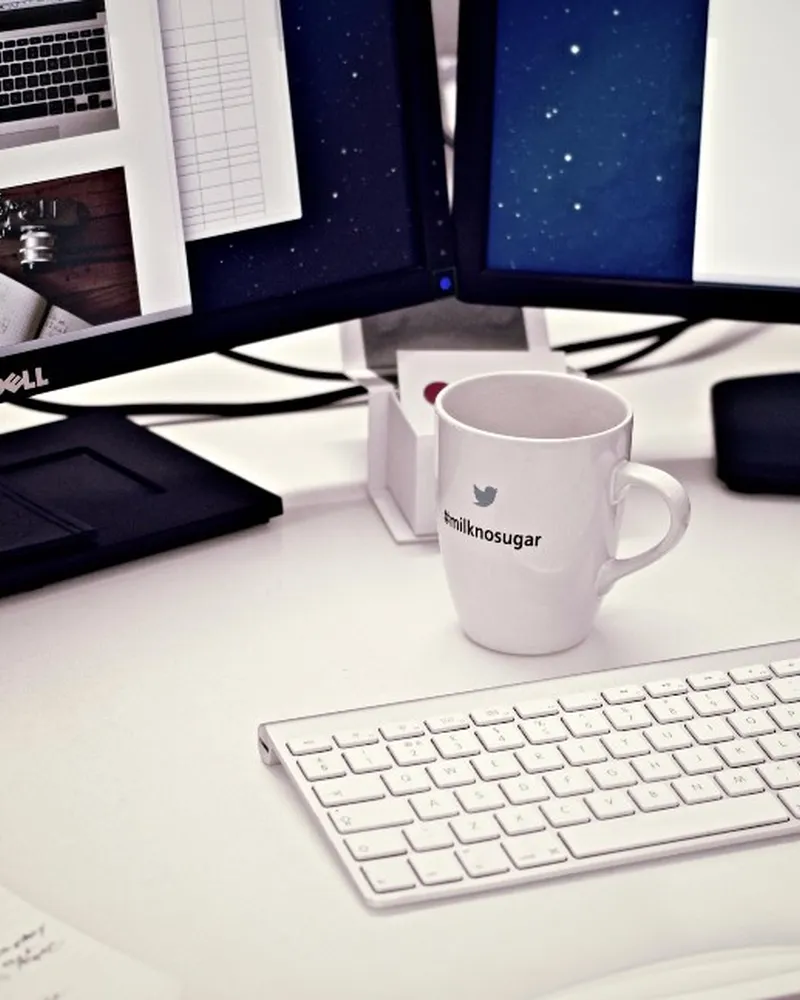 Illustrative photo of monitor arm / setup, not the exact HUANUO FlowLift Dual Monitor Stand