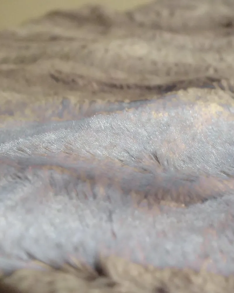 Illustrative photo of throw blanket, not the exact Amazon Basics Plush Throw